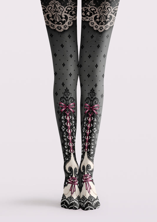 Gray printed tights with black and ivory lace motifs, pink ribbon bows, crisscross lacing and small diamond patterns.