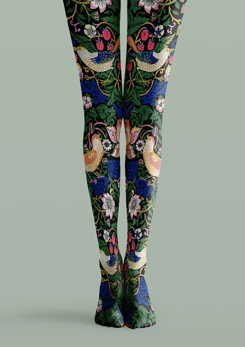 Black printed tights with illustrated birds, red strawberries, green leaves, blue foliage and pink flowers.
