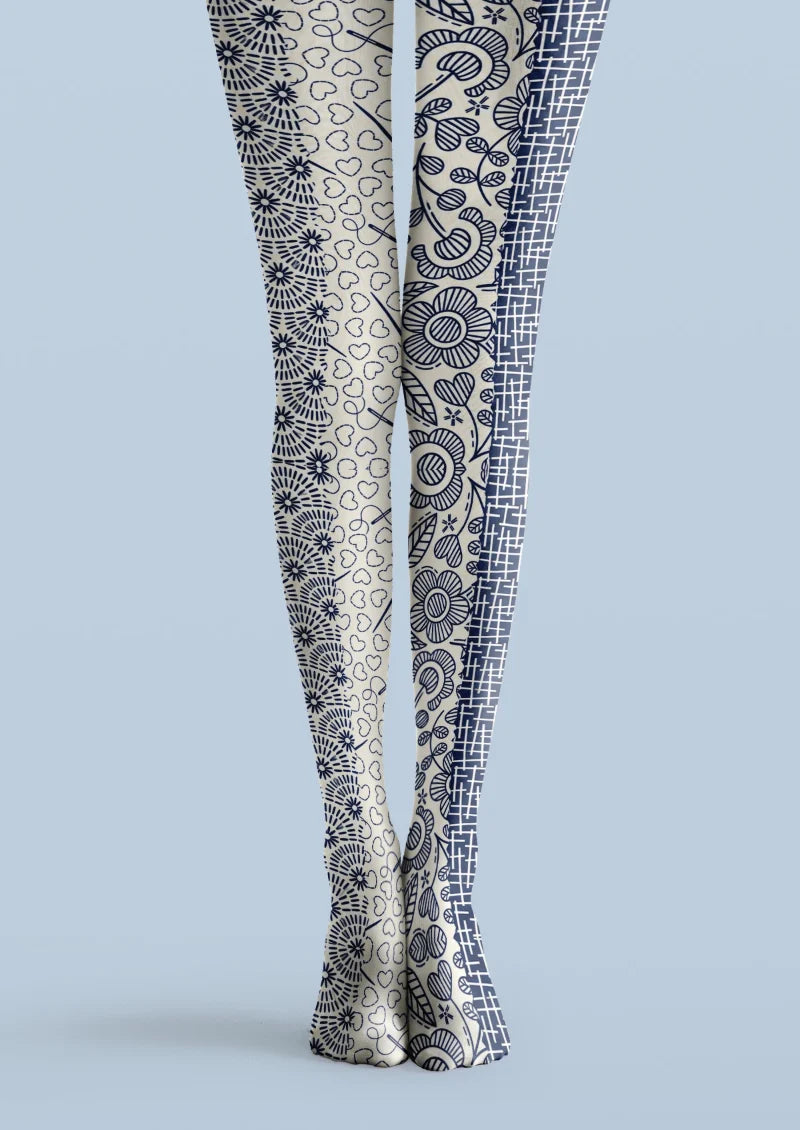 Ivory printed tights with navy floral motifs, outlined hearts, and a contrasting grid panel.