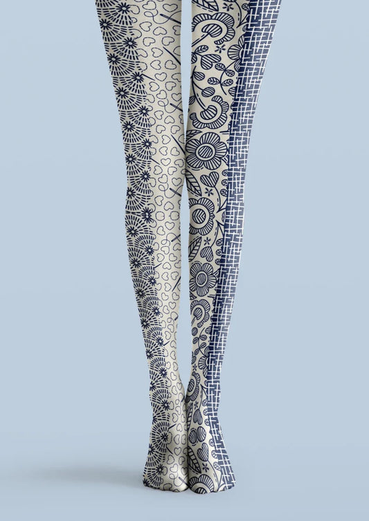 Ivory printed tights with navy floral motifs, outlined hearts, and a contrasting grid panel.
