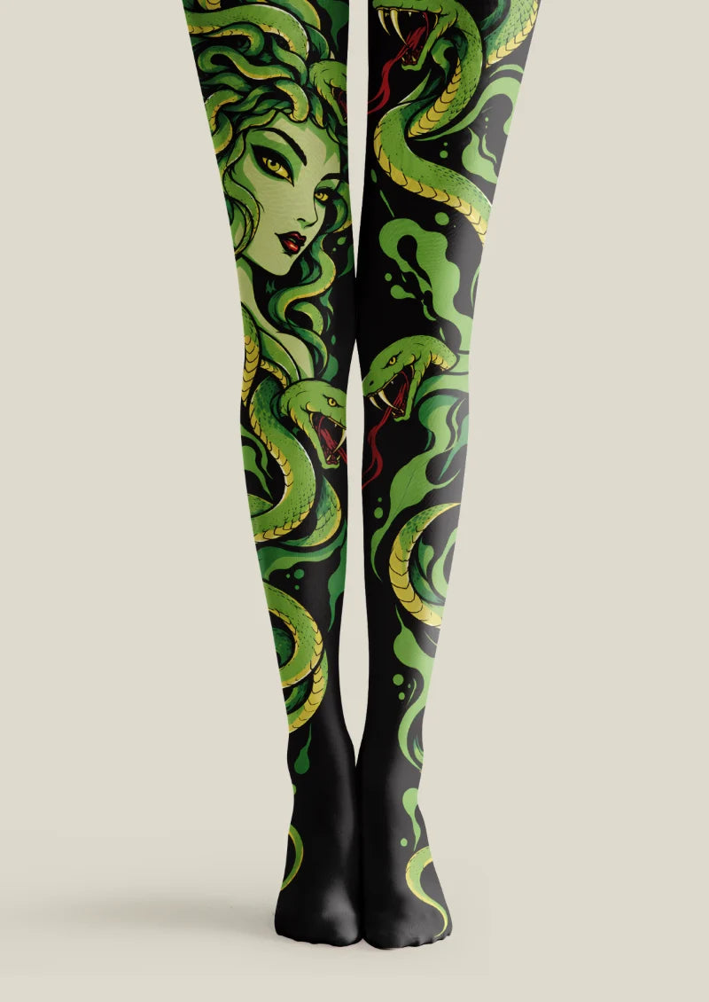 Black tights with green snakes, a Medusa-inspired face, ivory sculpture fragments and leaves; printed tights.