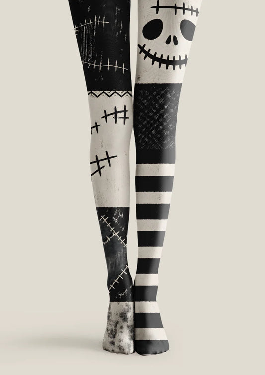 Black tights with ivory skull graphics, stitch motifs, distressed patchwork panels and horizontal stripes.