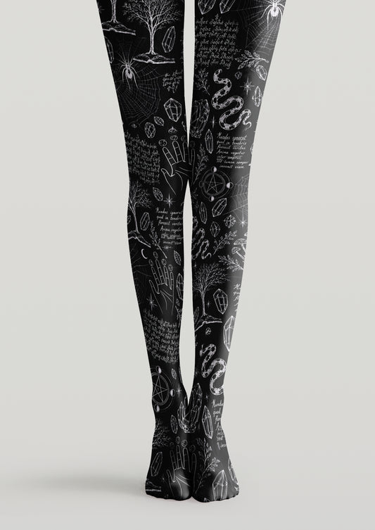 Black printed tights with snakes, crystals, spider webs, mystical hands, stars, and occult symbols