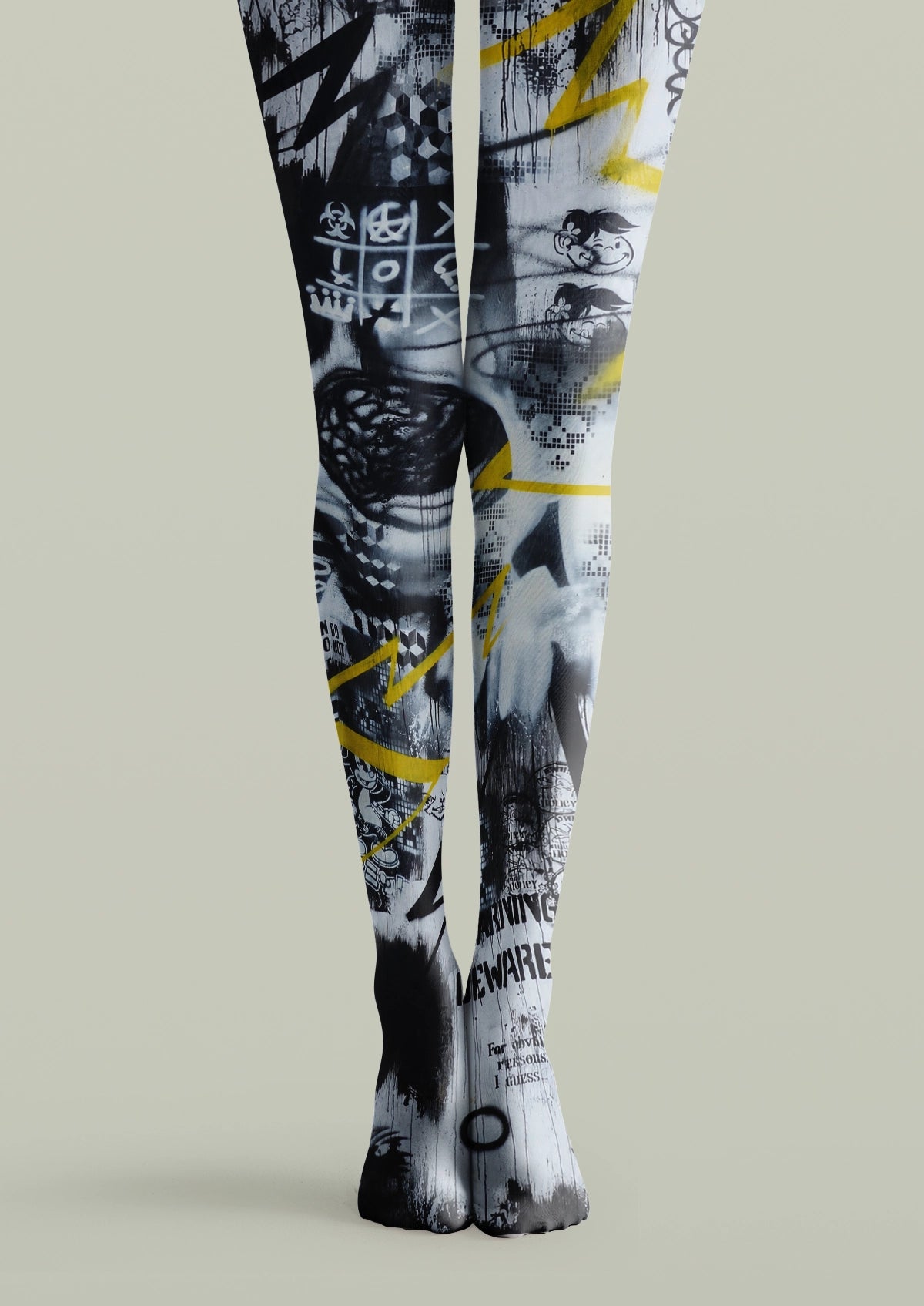 Black printed tights with yellow graffiti, arrows, checkerboard details, lettering, and abstract street-art graphics