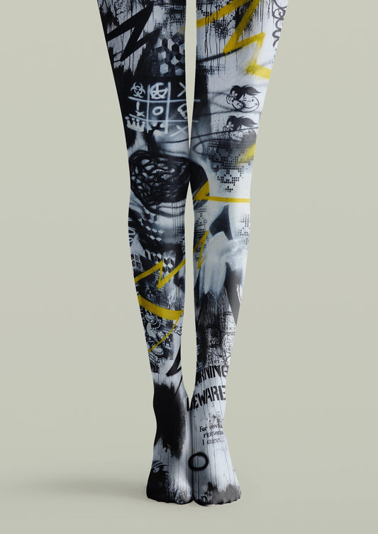 Black printed tights with yellow graffiti, arrows, checkerboard details, lettering, and abstract street-art graphics