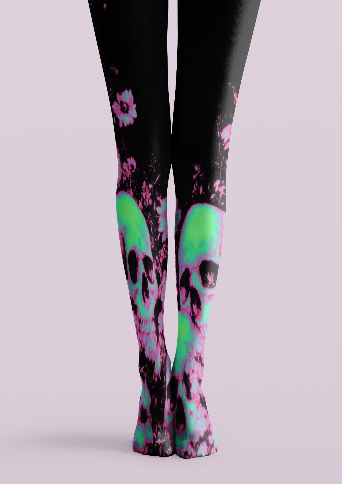 Black printed tights with neon green skulls, pink flowers, and vivid graphic accents across both legs.