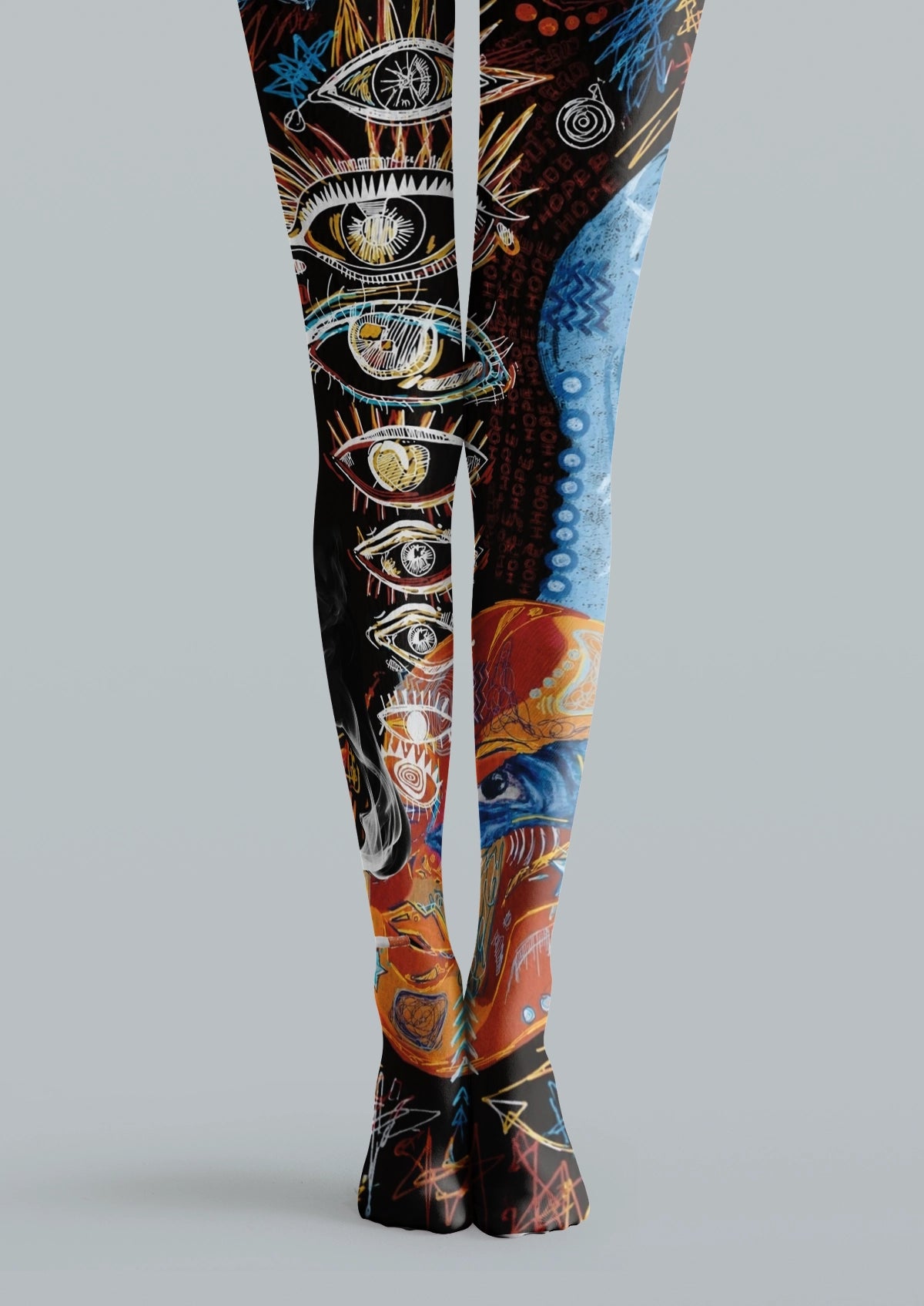 Black printed tights with blue and orange illustrated eyes, graphic symbols, sketch lines, and tattoo-style details