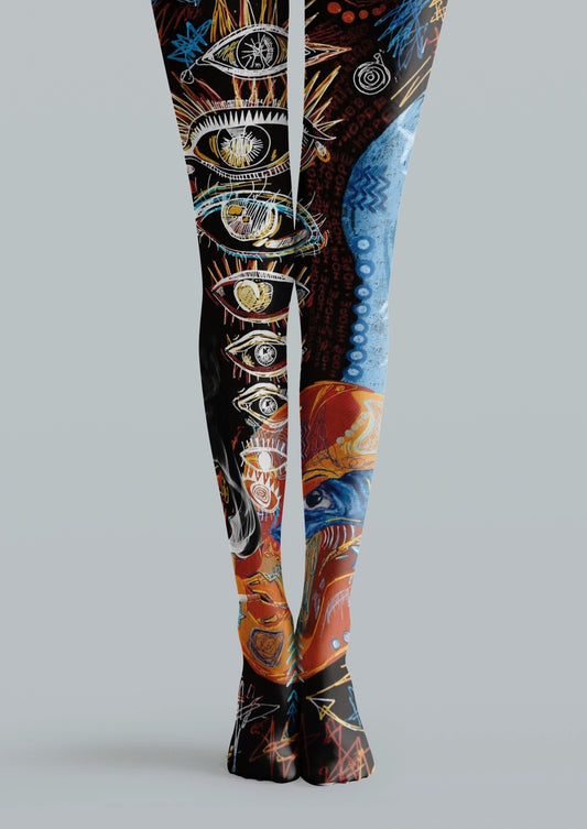 Black printed tights with blue and orange illustrated eyes, graphic symbols, sketch lines, and tattoo-style details