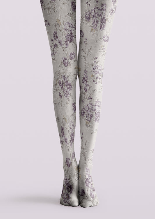 Ivory printed tights with muted lavender flowers, buds, and delicate botanical leaves across both legs