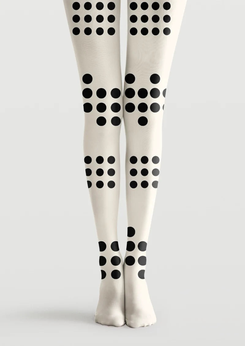 Ivory printed tights with bold black polka dots arranged in varied grid formations along the legs