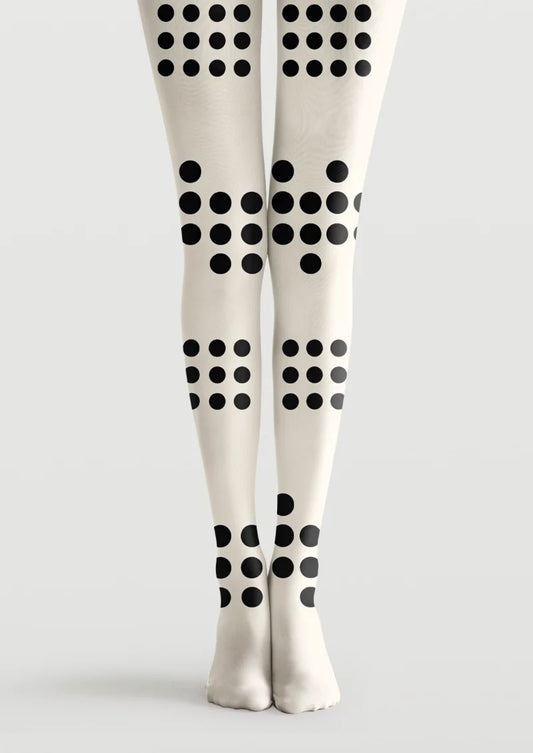 Ivory printed tights with bold black polka dots arranged in varied grid formations along the legs