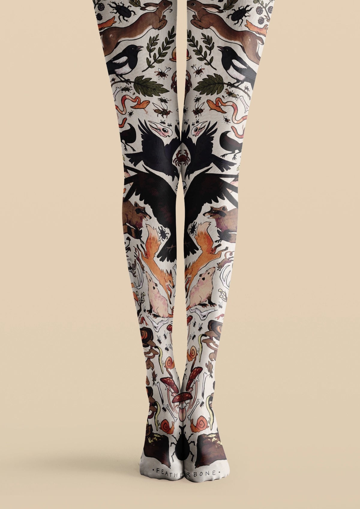White printed tights with rabbits, black birds, foxes, insects, mushrooms, snails, and leafy illustrations