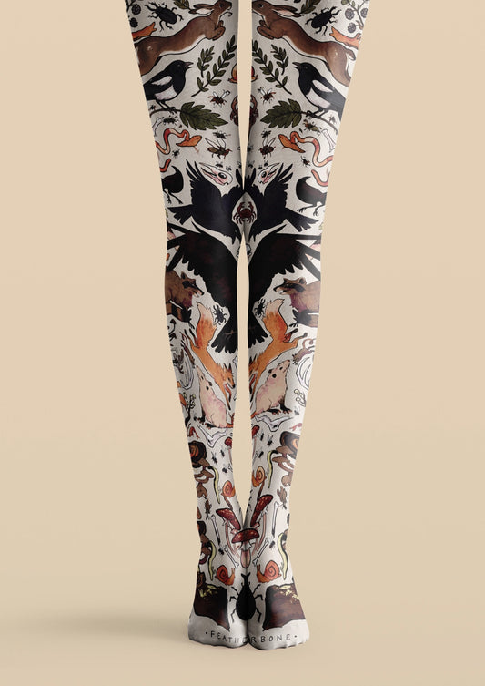 White printed tights with rabbits, black birds, foxes, insects, mushrooms, snails, and leafy illustrations