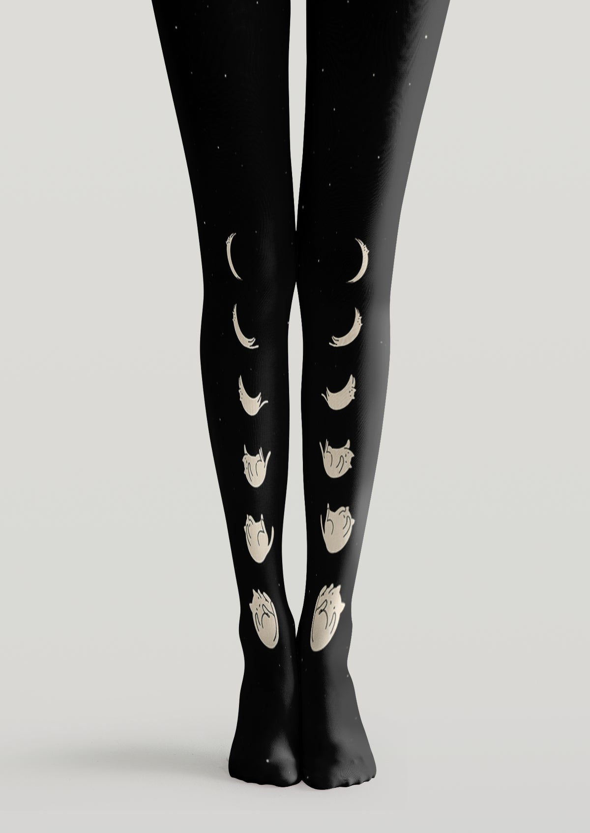 Black printed tights with ivory moon phases arranged vertically across both legs and subtle star accents