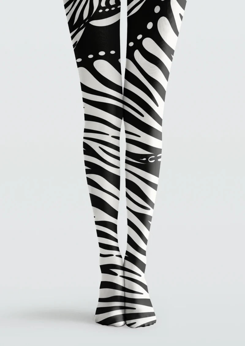 Black and white tights with zebra-inspired stripes and scattered dot accents