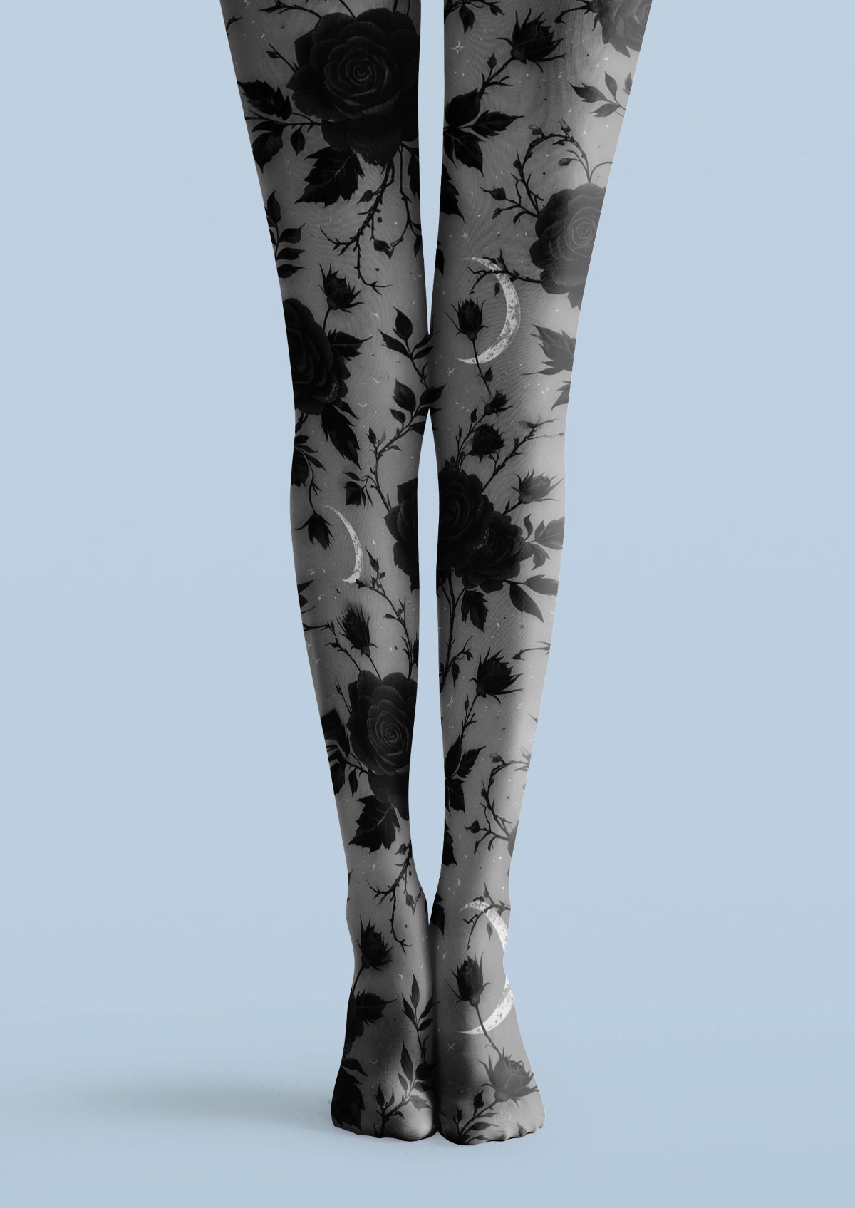 Gray printed tights with black roses, leafy stems, flower buds, and pale crescent moon motifs.