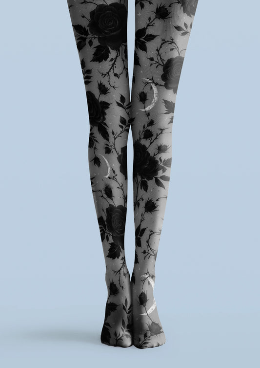Gray printed tights with black roses, leafy stems, flower buds, and pale crescent moon motifs.