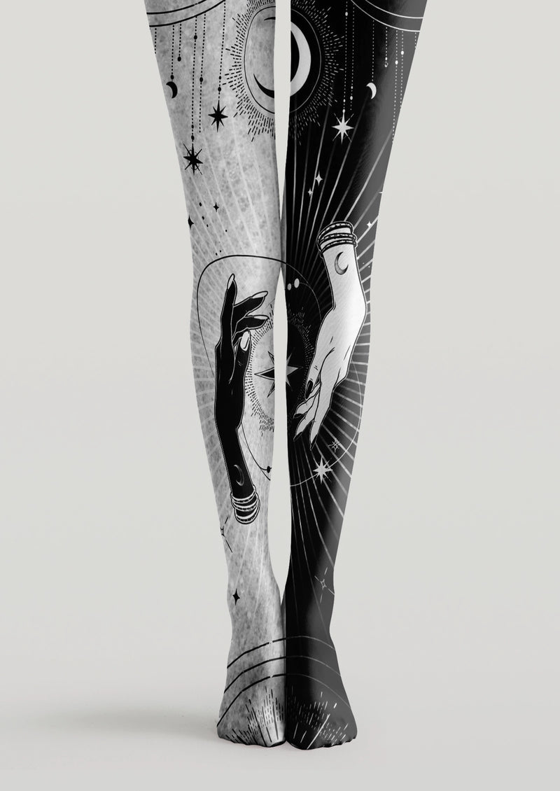 Black and white printed tights with mystical hands, crescent moons, stars, and celestial linework