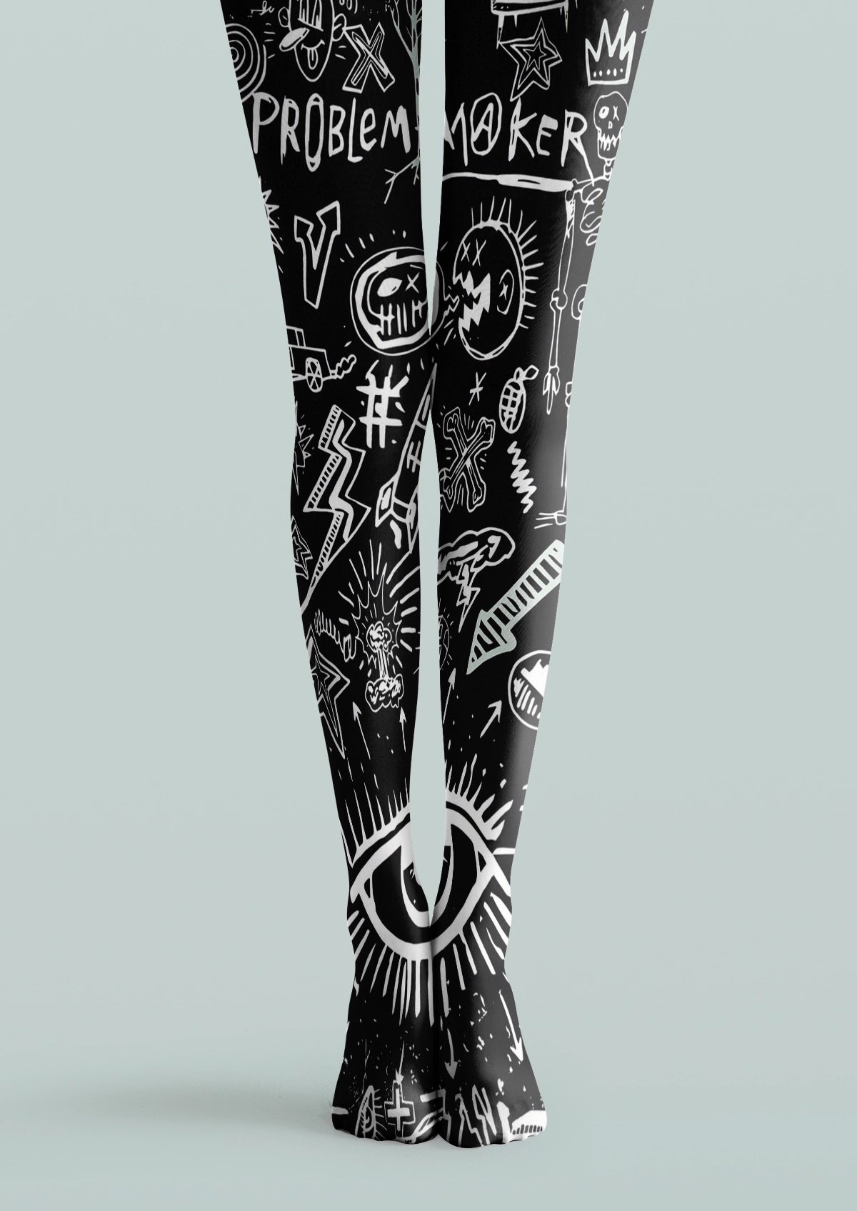 Black printed tights with white eye, skull, lightning, star, crown, and hand-drawn graffiti motifs