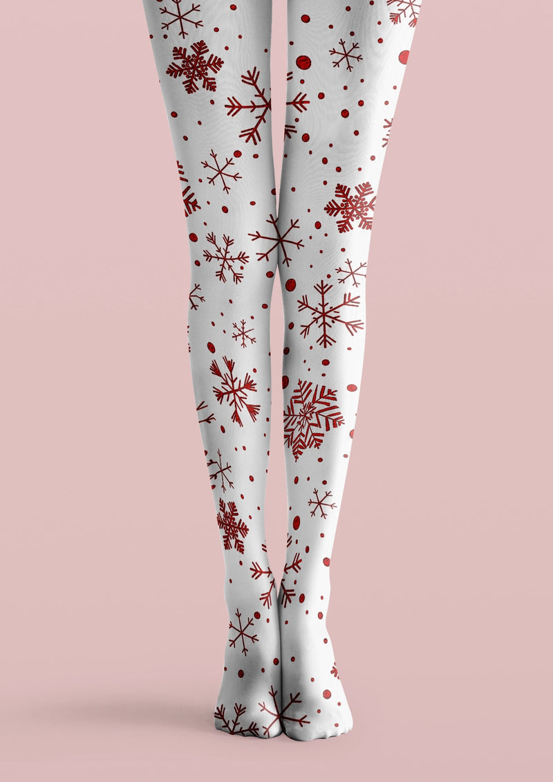White printed tights with red snowflakes in varied sizes and scattered red dot details across both legs.