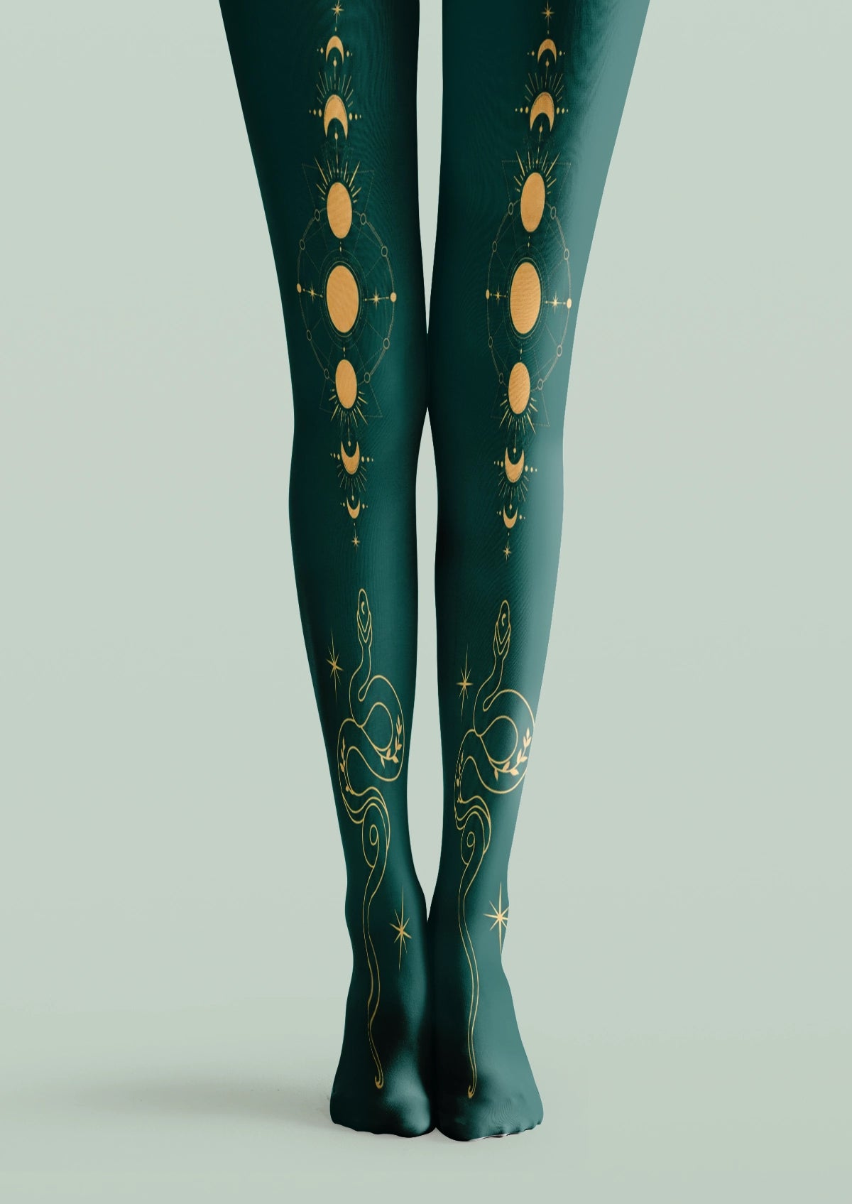 Green printed tights with yellow moon phases, celestial symbols, stars, and winding snake motifs