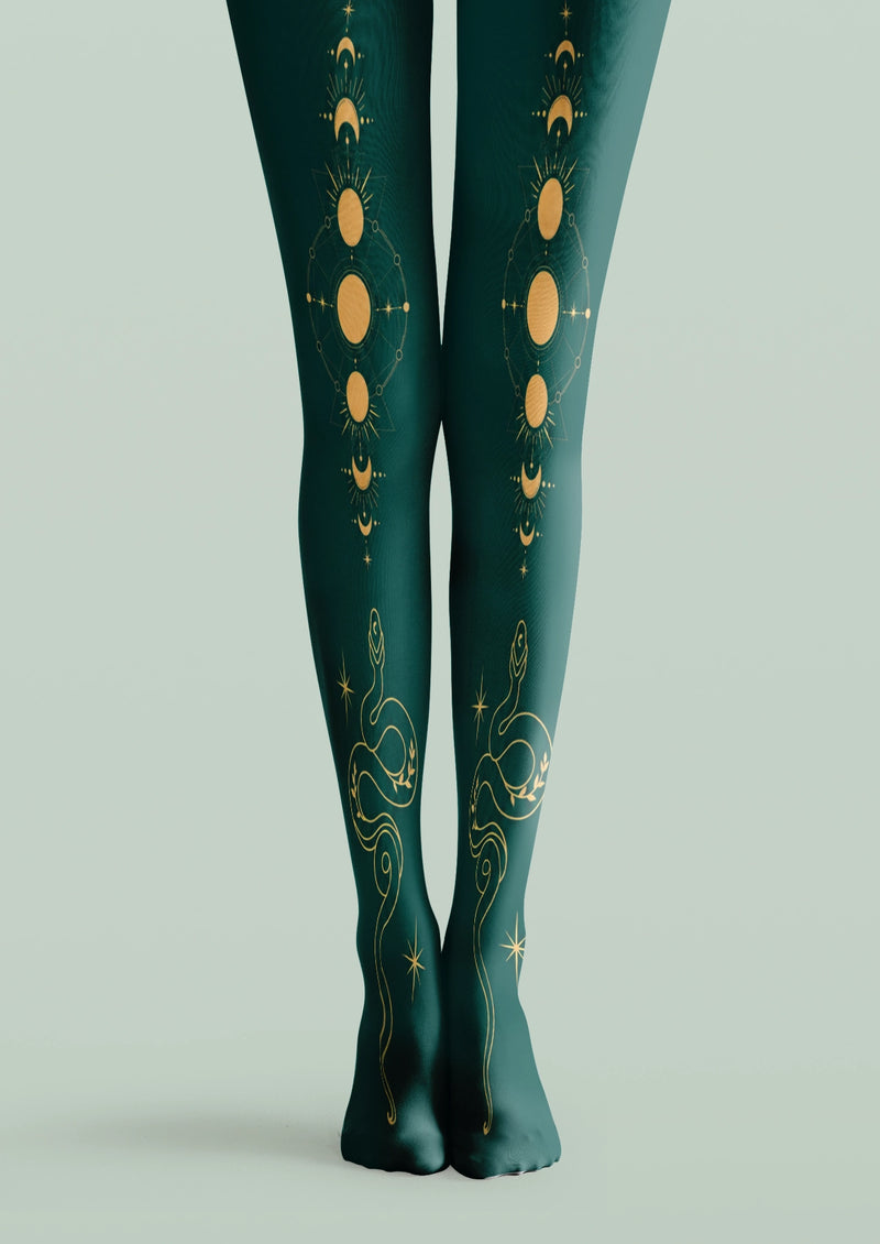 Green printed tights with yellow moon phases, celestial symbols, stars, and winding snake motifs