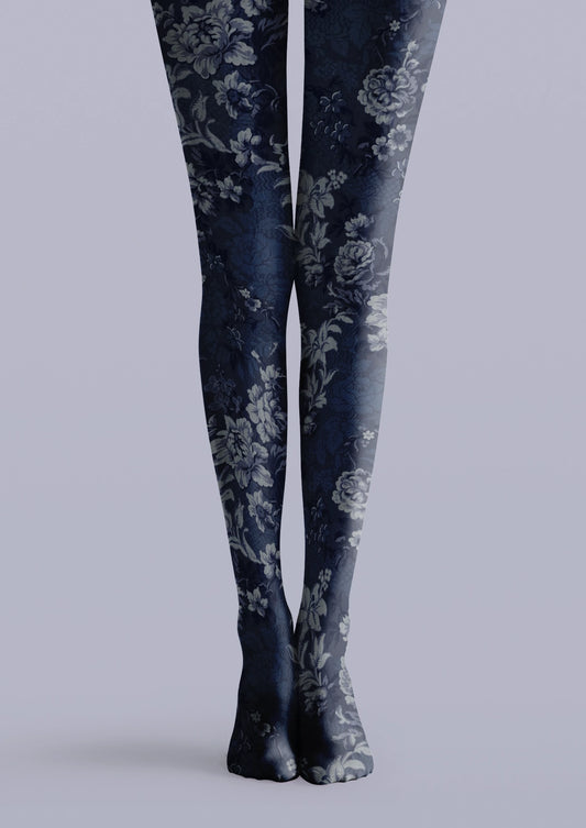 Navy printed tights with gray-blue flowers, layered leaves, and vintage floral details across both legs.