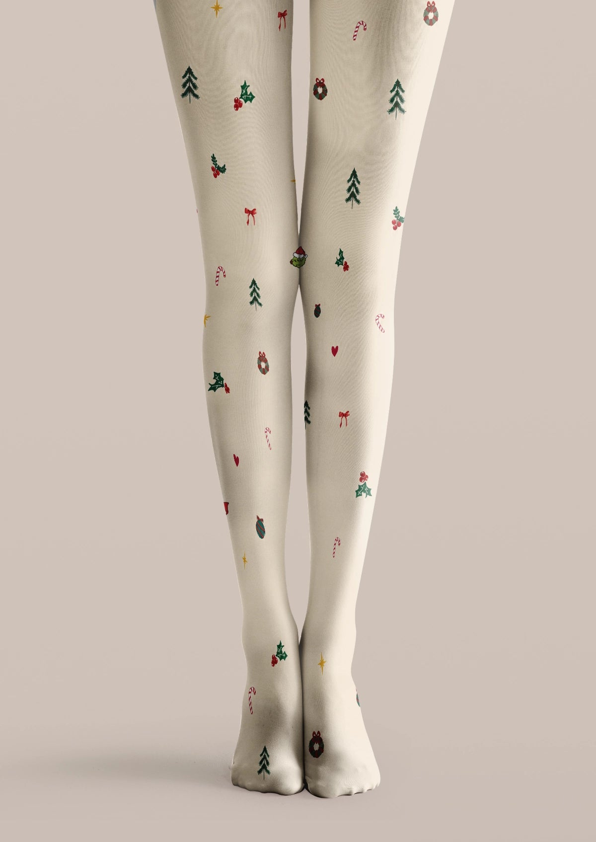 Ivory printed tights with Christmas trees, red bows, candy canes, holly, ornaments and festive scattered motifs.