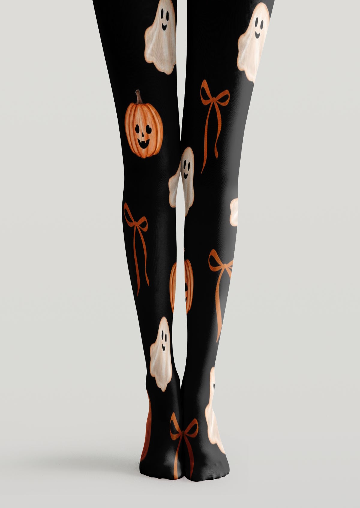 Black printed tights with smiling ghosts, pumpkins, and ribbon bows across both legs