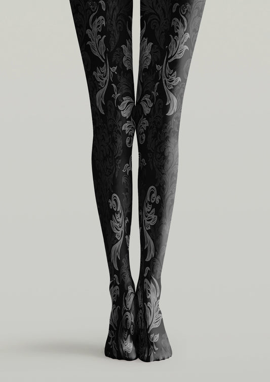 Black printed tights with gray botanical leaves, curved stems, and layered foliage motifs across both legs.