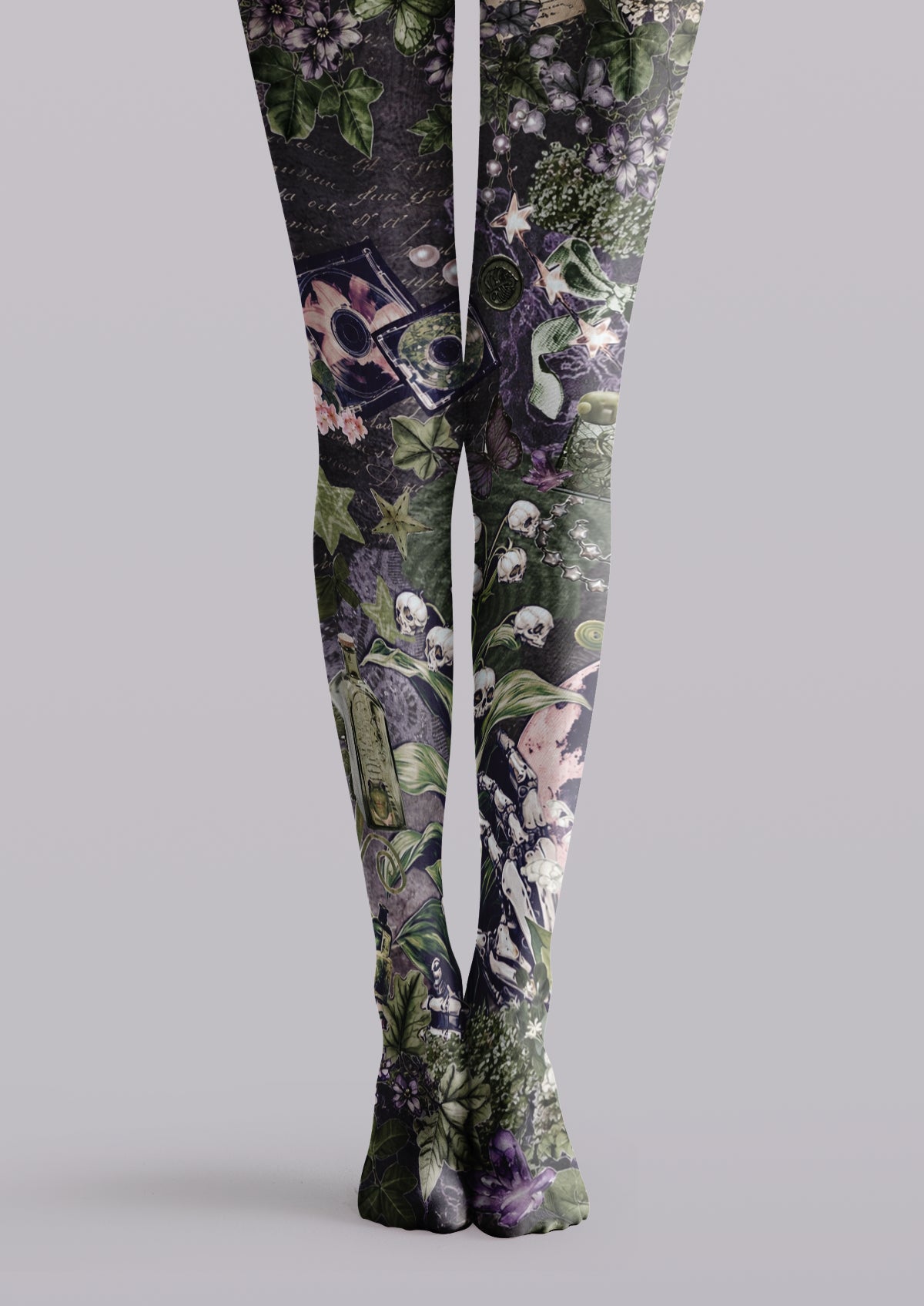 Black printed tights with green ivy, purple flowers, skulls, skeletal figures, stars, and gothic collage motifs
