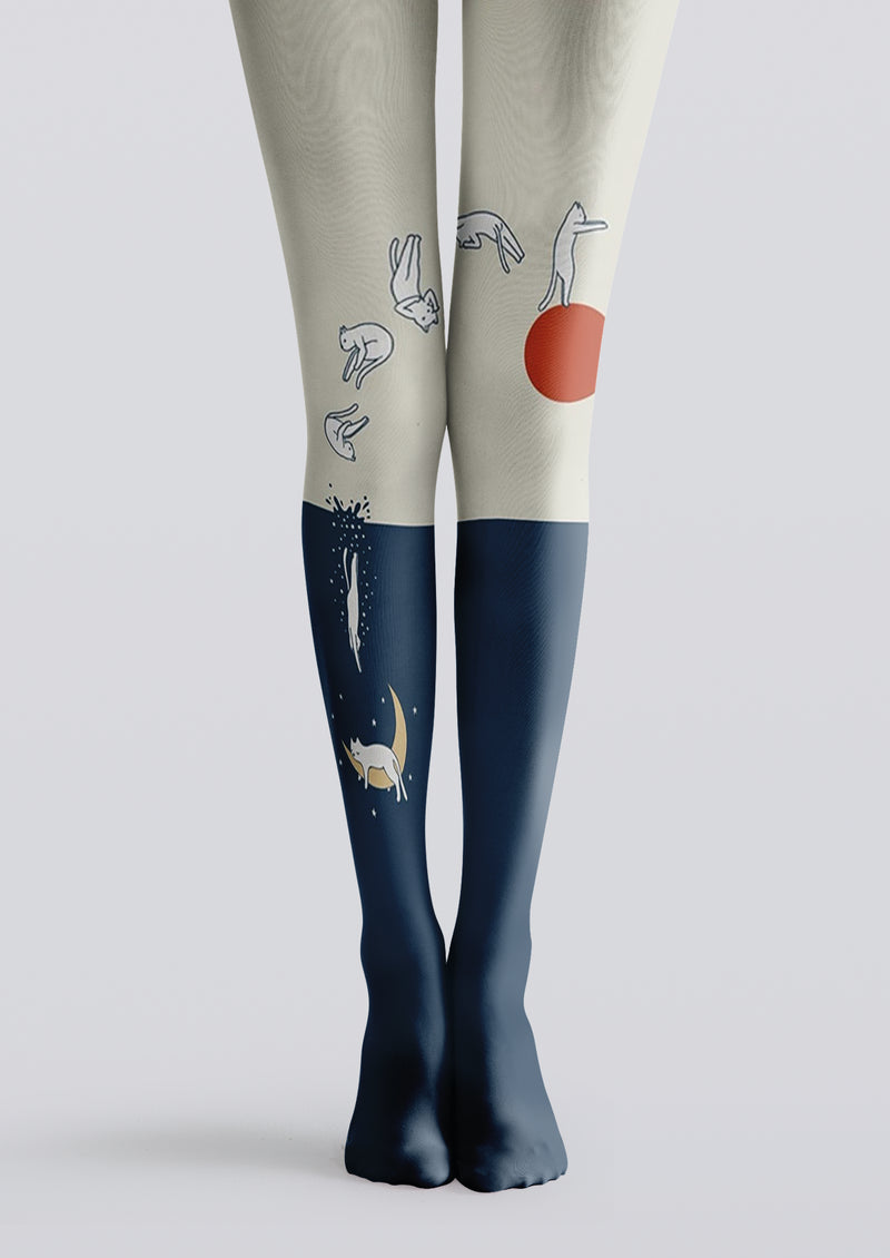 Ivory and navy printed tights with cats, orange sun, crescent moon, stars, and shooting-star details