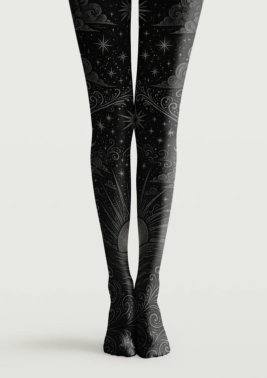 Black printed tights with gray stars, swirling clouds, ornamental lines, and a rising sun motif