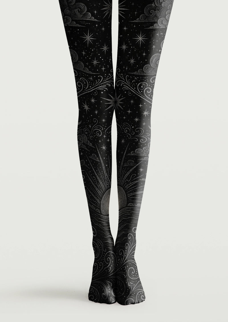 Black printed tights with gray stars, swirling clouds, ornamental lines, and a rising sun motif