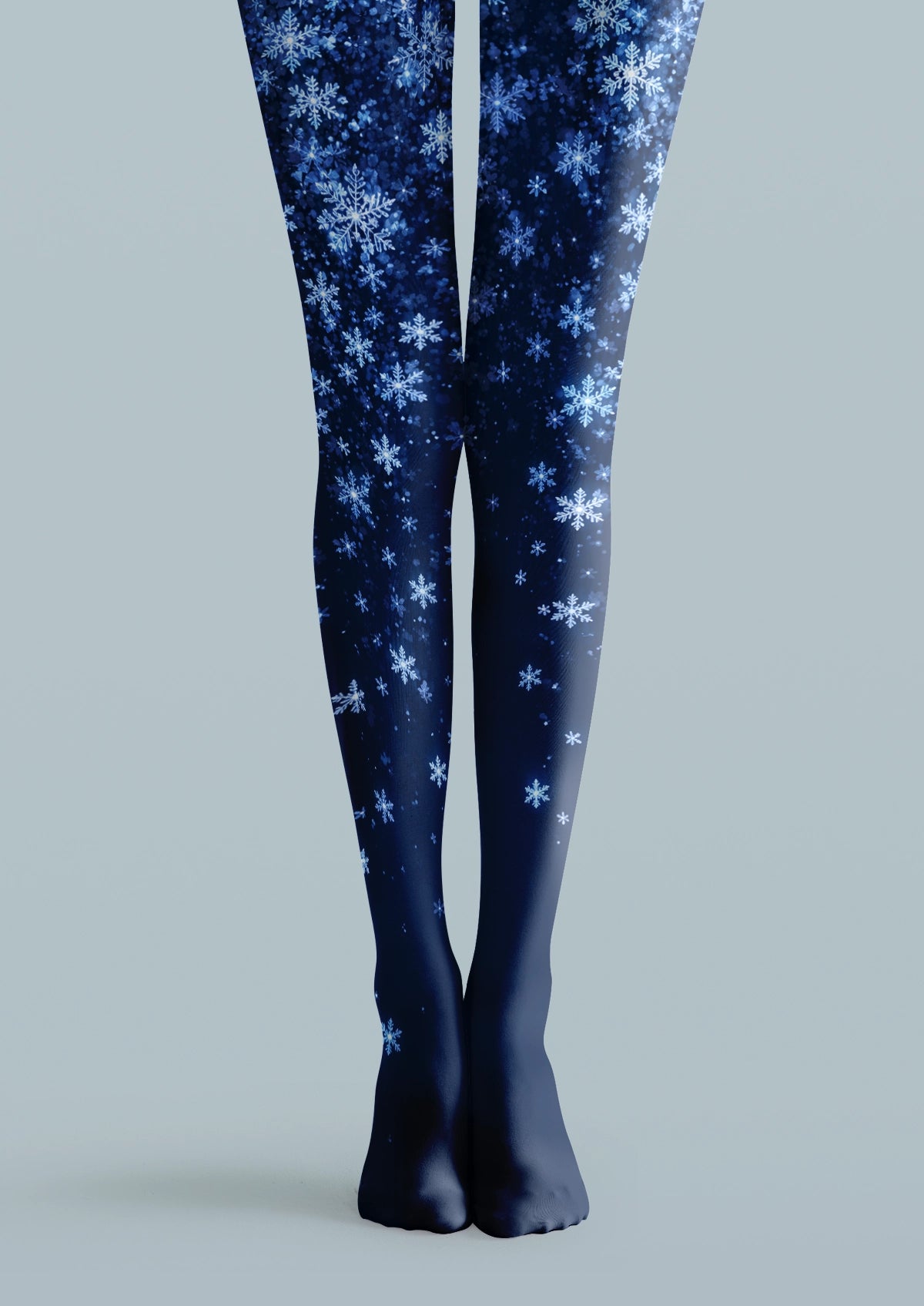 Navy printed tights with white and blue snowflakes in varied sizes across both legs.