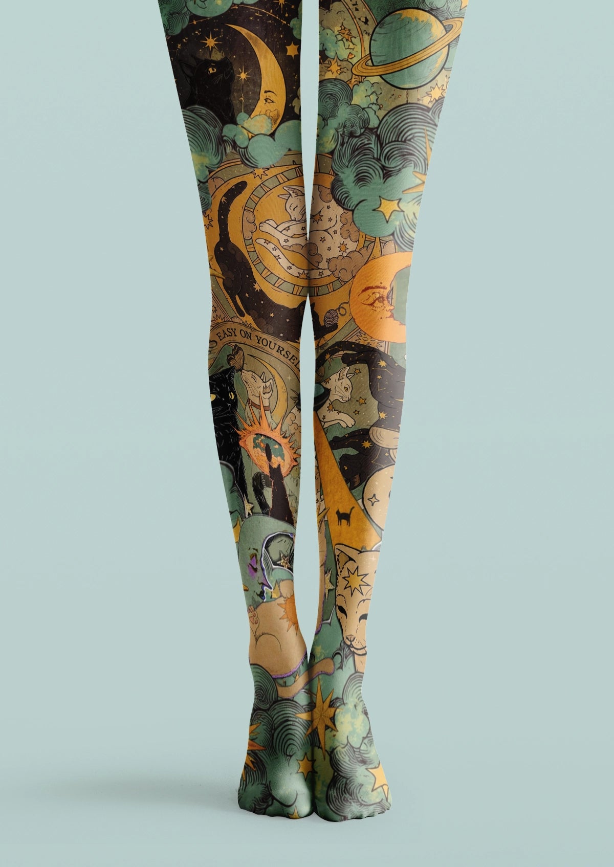 Green printed tights with moons, planets, stars, cats, clouds, and vintage astrology illustrations
