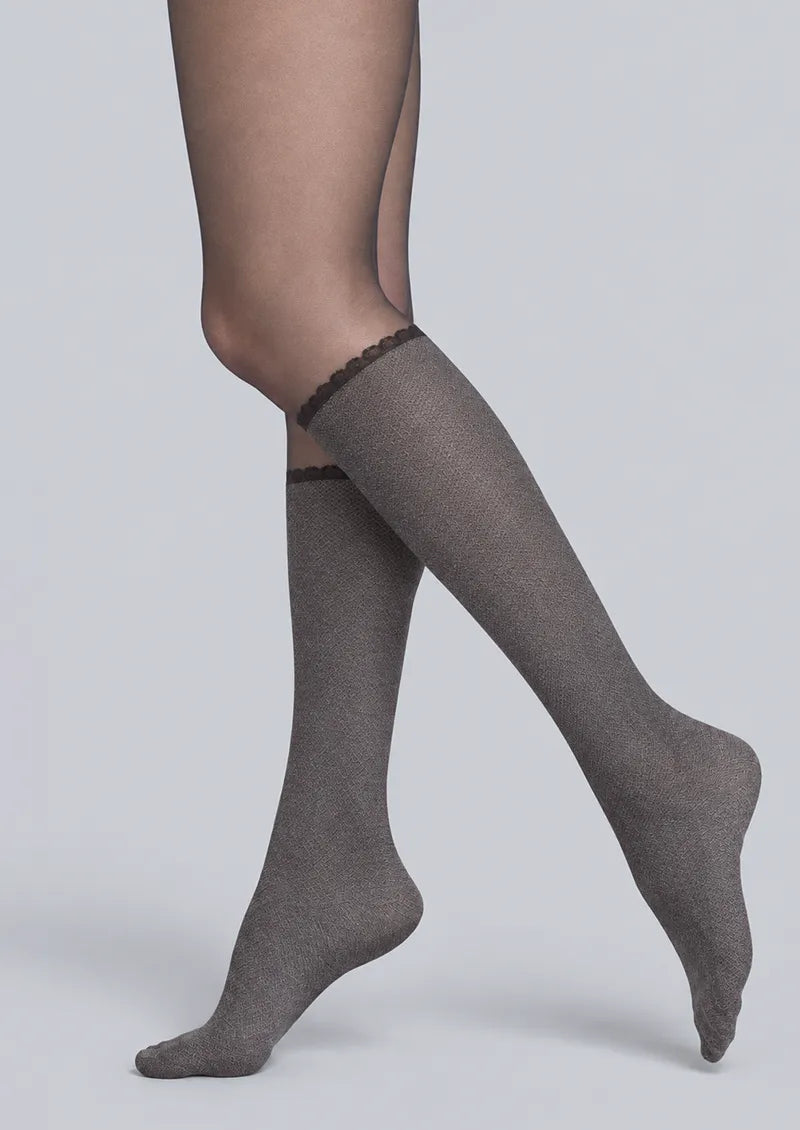 Black printed tights with a faux knee-high geometric lower-leg design and dark scalloped trim below the knees
