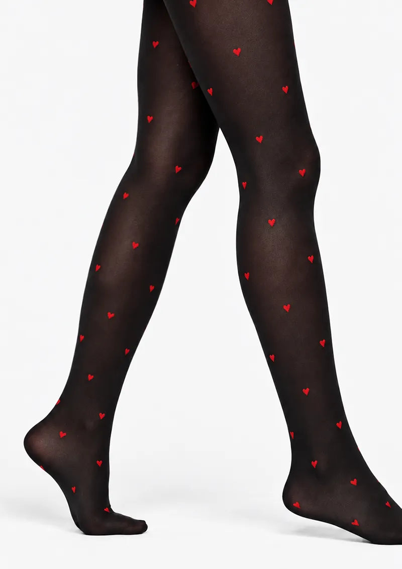 Black printed tights with small scattered red heart motifs across the legs and feet