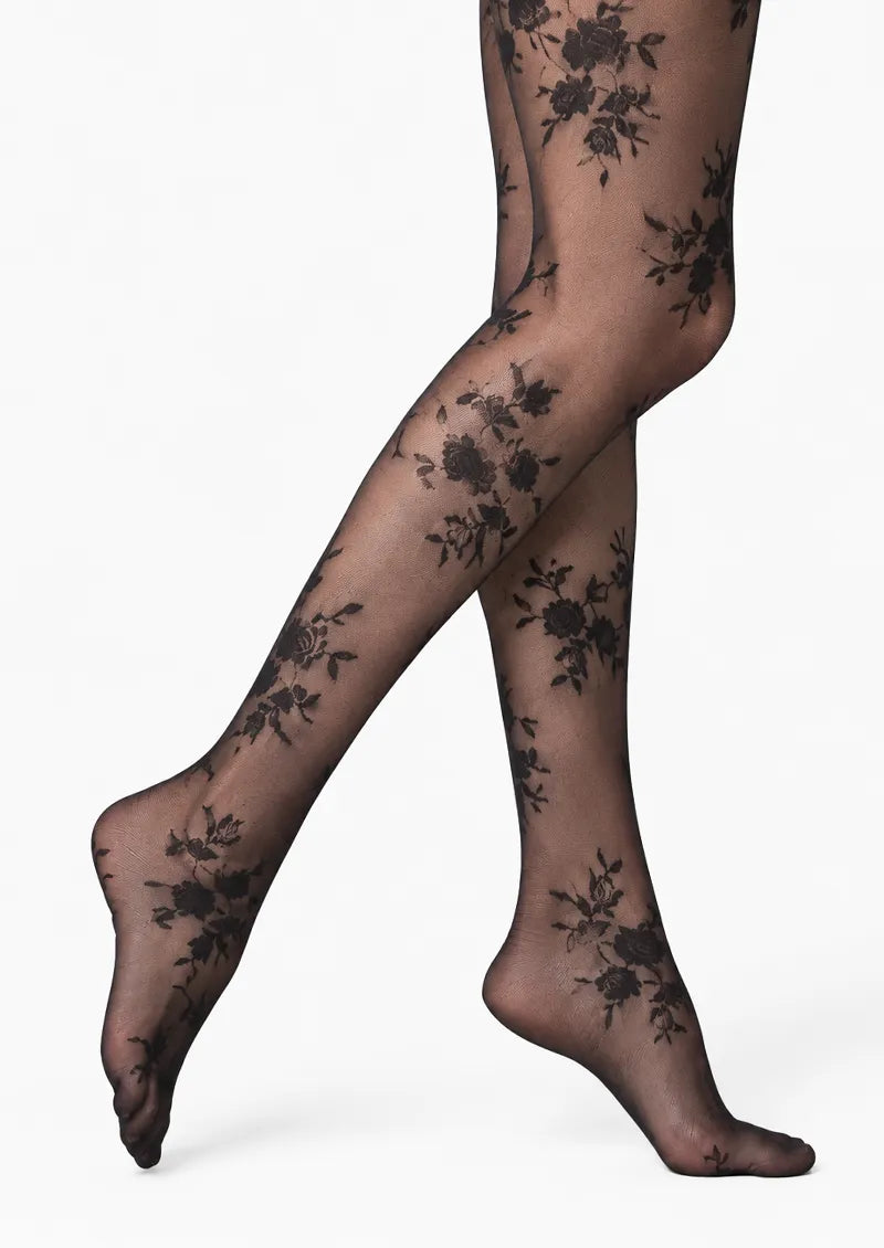 Black printed tights with scattered rose bouquets and delicate lace-effect floral details across the legs and feet