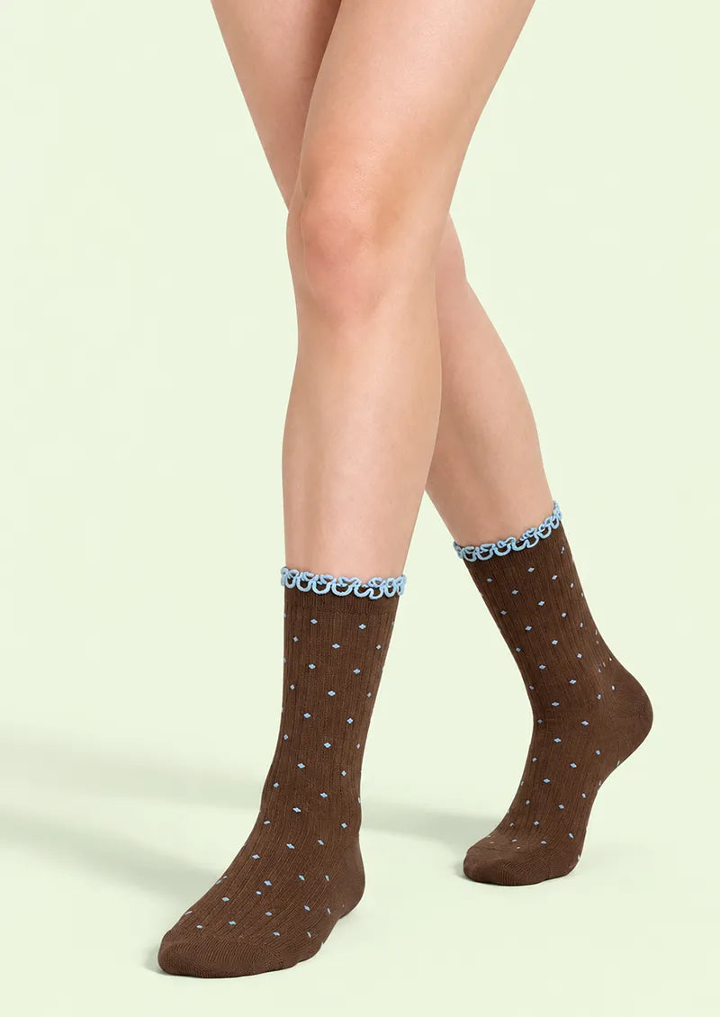Front view of brown Crew Socks with blue polka dots, ribbed texture, and a blue ruffled cuff