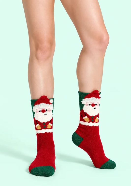 Front view of red Crew Socks with a Santa face and green heel and toe accents