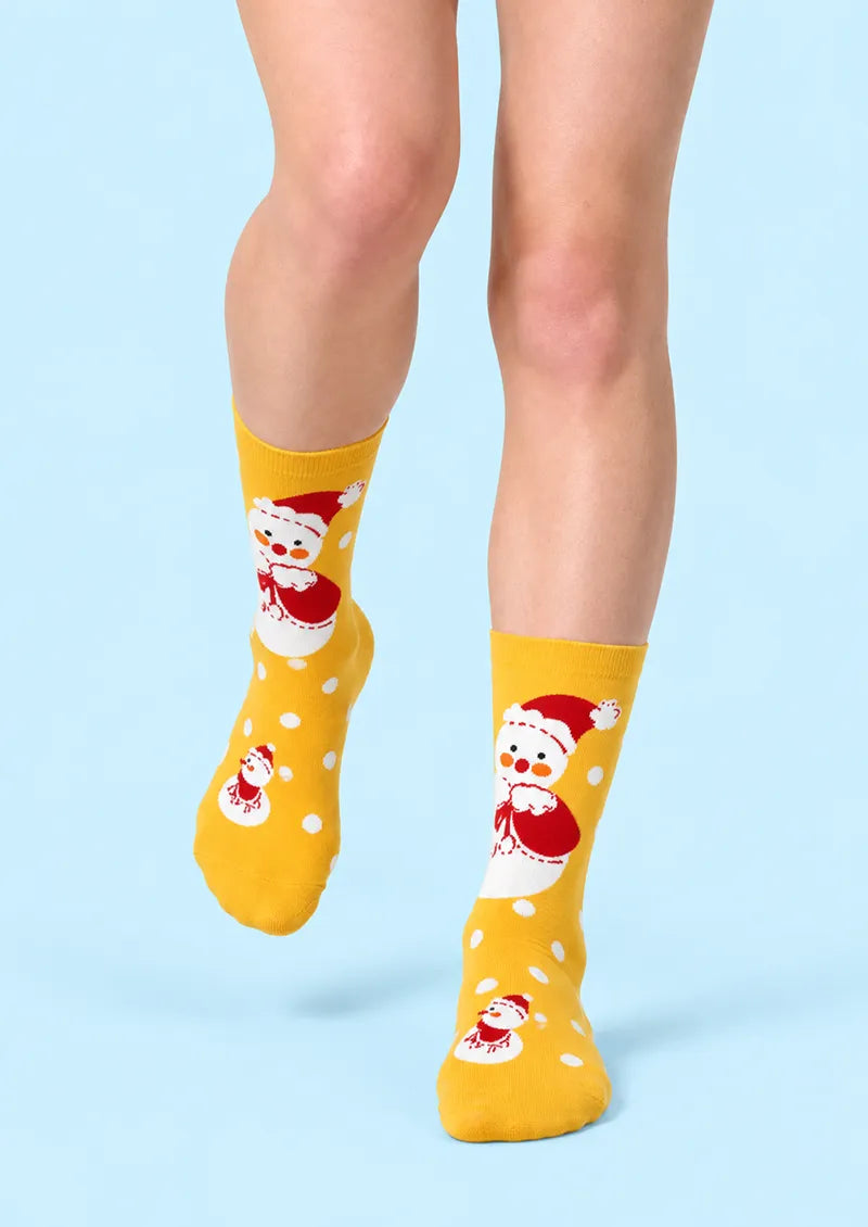 Front view of yellow Crew Socks with a large snowman motif and white polka dot details