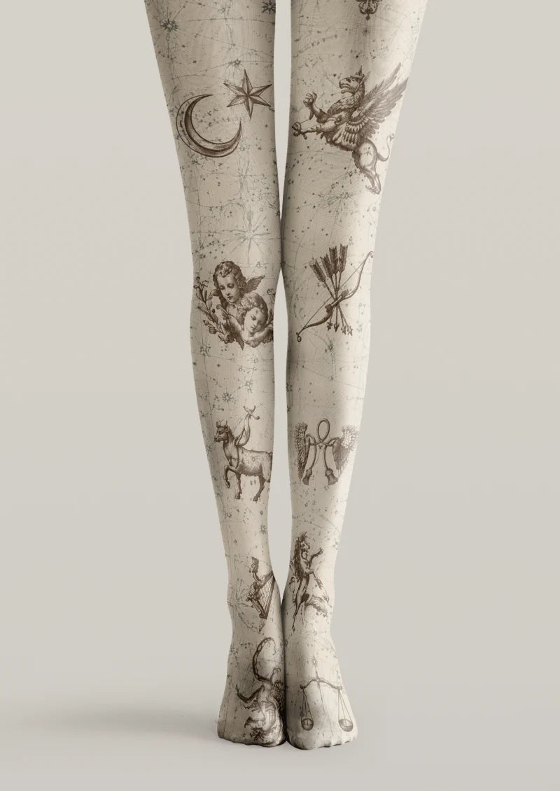 Ivory printed tights with brown zodiac illustrations, a crescent moon, stars, scales, a scorpion, and fine connecting lines.