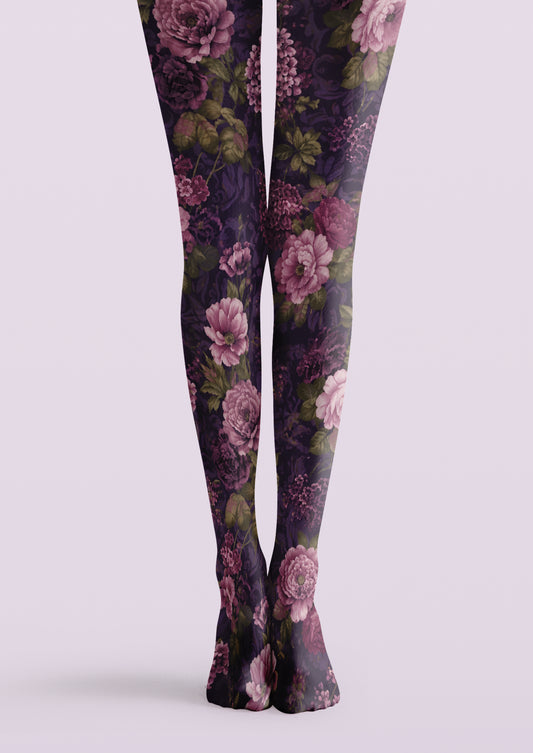 Purple printed tights with pink and mauve flowers and green leaves on a dark floral background