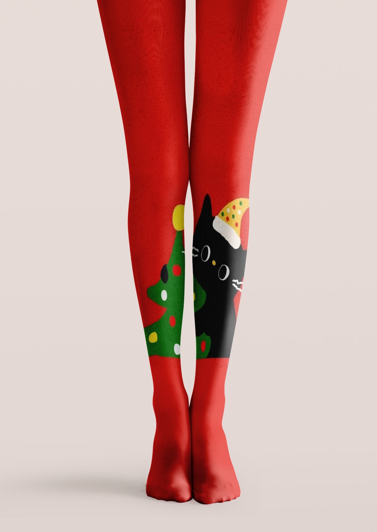 Red printed tights with a green Christmas tree, colorful ornaments and a black cat wearing a festive hat.