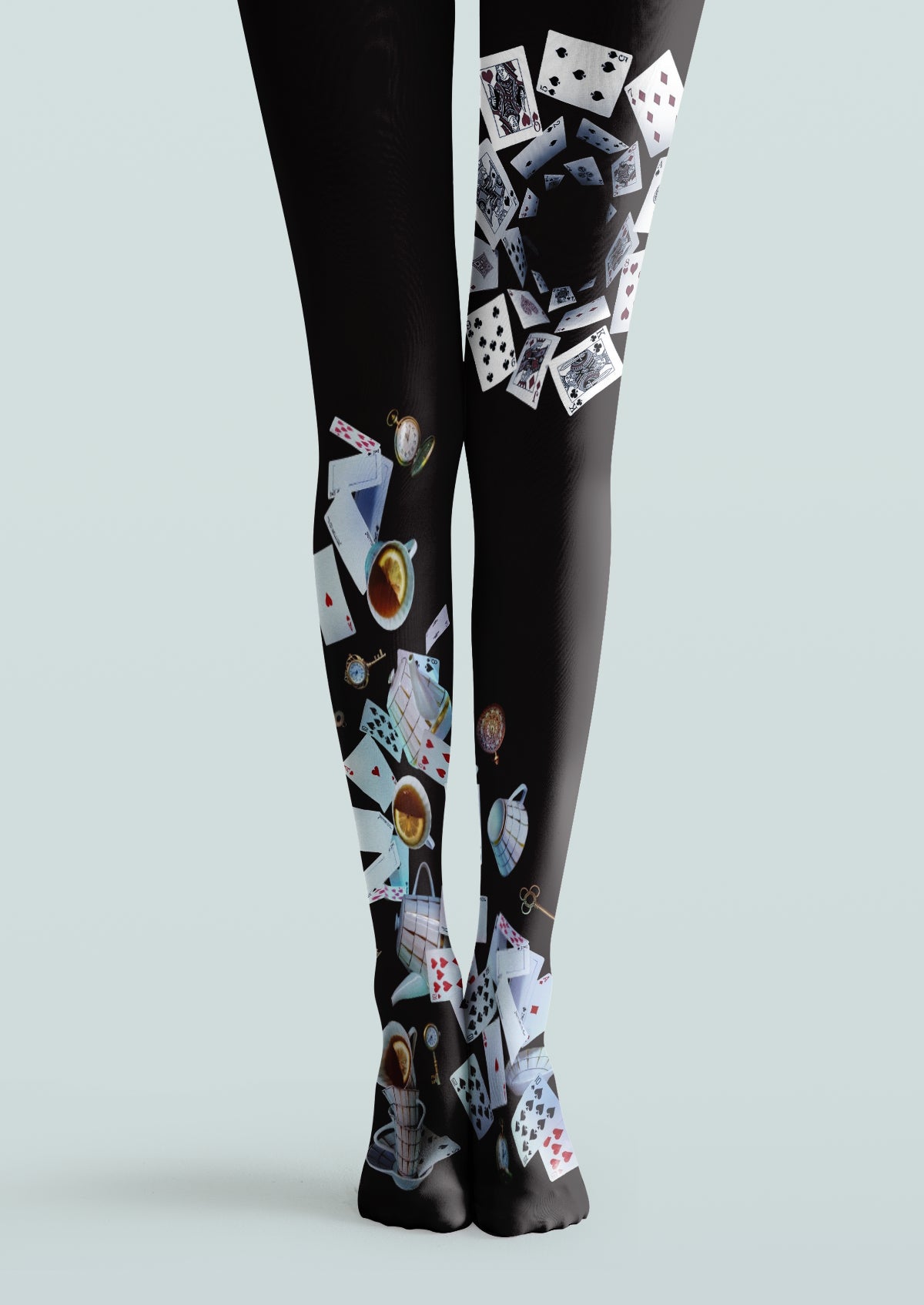 Black printed tights featuring playing cards, teacups, pocket watches, and small decorative motifs.