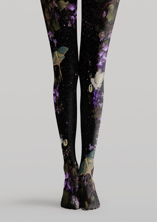 Black printed tights with purple flowers, green moths, glowing lanterns, winding vines and stars.