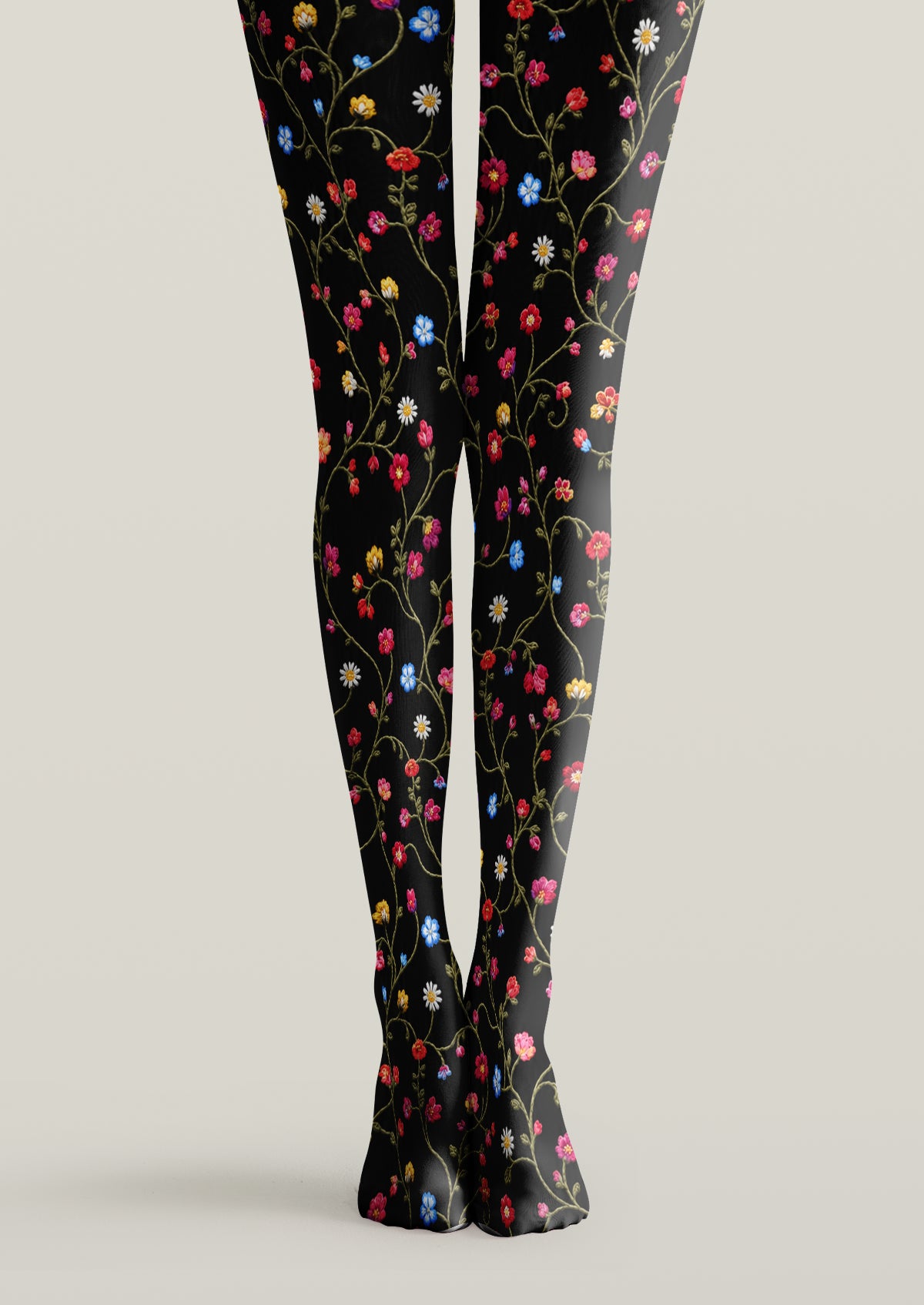 Black printed tights with multicolored embroidered look flowers, green vines, and delicate leaves.
