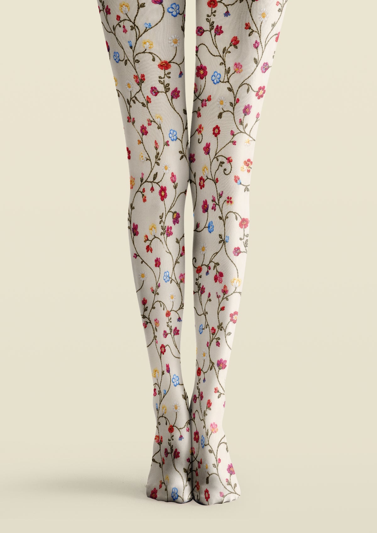 Ivory printed tights with multicolored embroidered-look flowers, winding green vines, and delicate leaves.