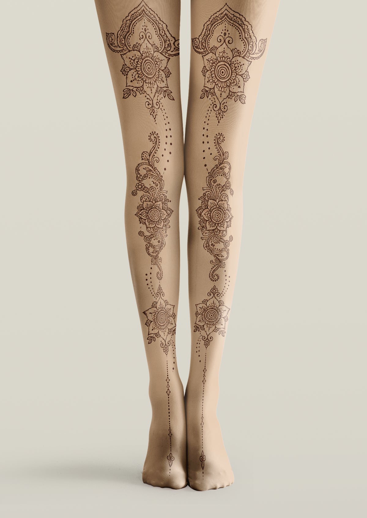 Beige printed tights with symmetrical brown floral tattoo motifs, ornamental scrollwork, and dotted lines.
